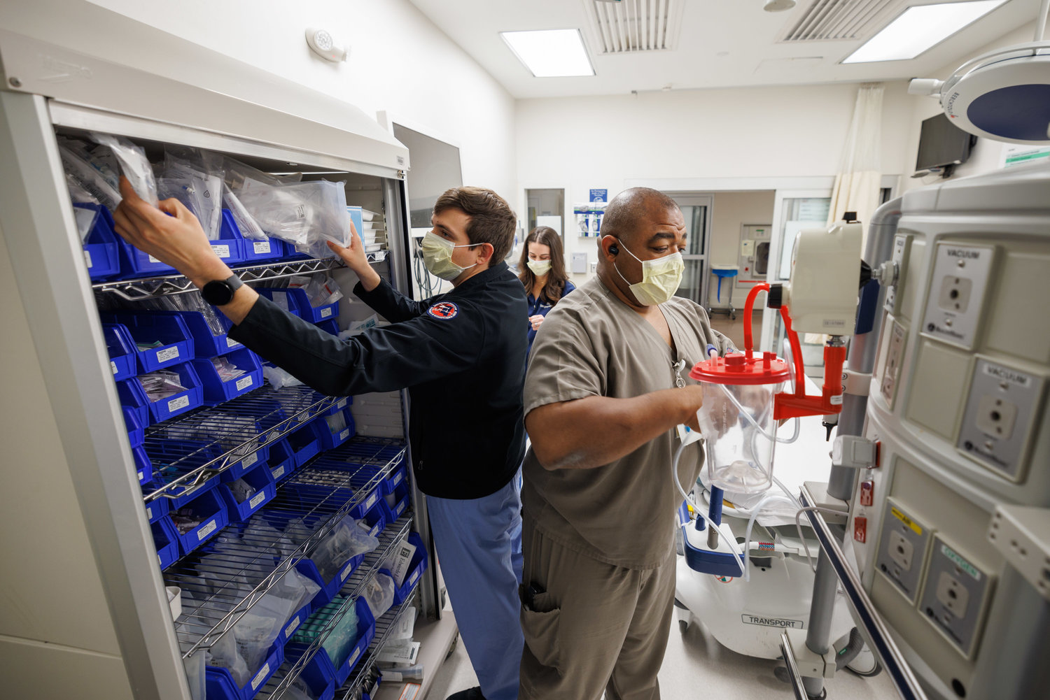 Emergency Medicine Resident Dr. Andrew Garza, left, Pharmacist Stephanie Tesseneer, background, and Respiratory Therapist Charles Patton stock supplies in a Trauma Room in the Adult Emergency Department at the University of Mississippi Medical Center.